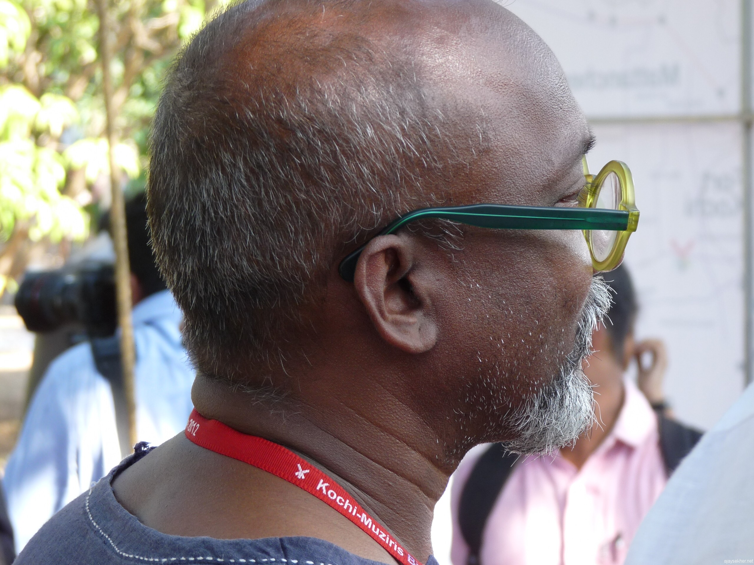 The lonliness of the hero:  Bose Krishnamachari lost in deep though amidst the crowd at Kochi Biennale 2012.