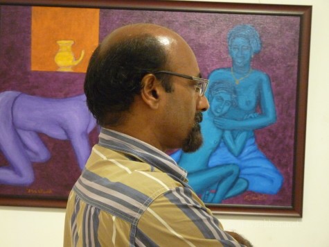 Dr Umar Tharamel lost amidst paintings in image/carnage 2 at Calicut.