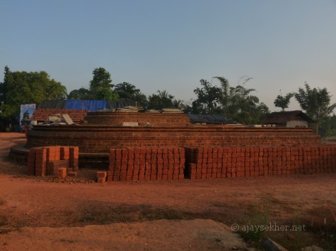 The huge apsidal (Gajaprishta) base of the northern shrine of Murukan now being rennovated.  It was rediscovered in 1992 beneath a heap of red soil.