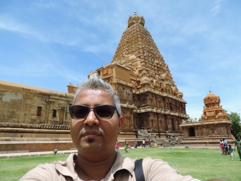 The author, Ajay Sekher in Big temple at Tanjavur. This Siva temple was built in AD 1010 by Rajaraja Chola, but it shows remarkable Buddhist connections in fresco and reliefs.