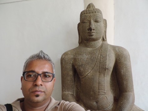 The author, Ajay Sekher with the Buddha at Tanjavur Palace Museum