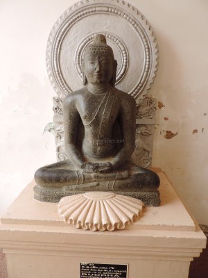 Buddha 2 at Tanjavur Palace Museum. The Mayana style hallow is added and not part of the original Teravada sculpture.